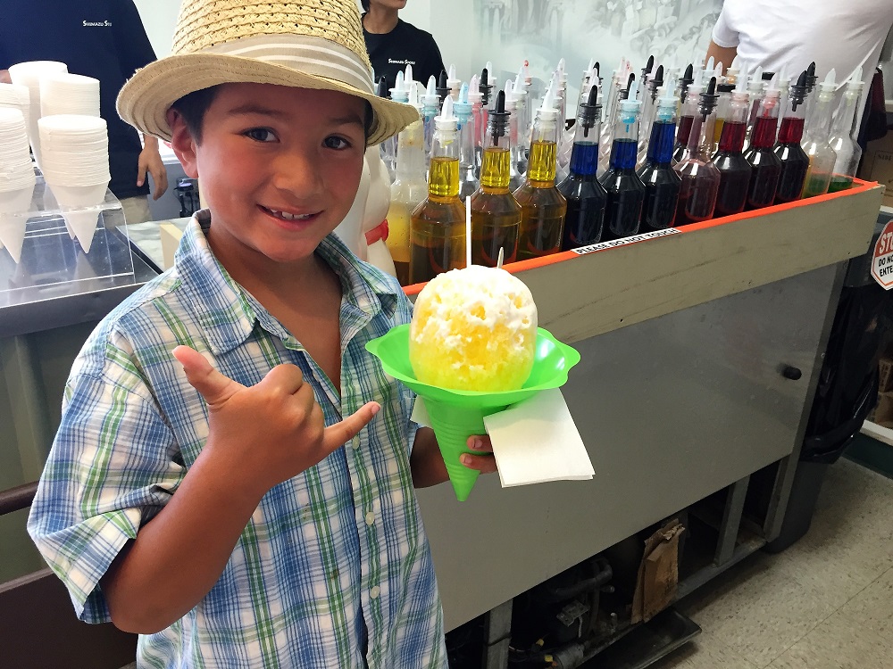 Hawaiian Shave Ice is a refreshing and colorful frozen treat popular in Hawaii, made by shaving a block of ice and topping it with a variety of flavored syrups, often accompanied by sweet toppings like condensed milk and azuki beans.
